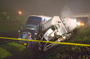 A pair of tractor trailers rest in the median as the fire from a third one behind the two burn on I-81 in Northern Virginia early Tuesday morning.